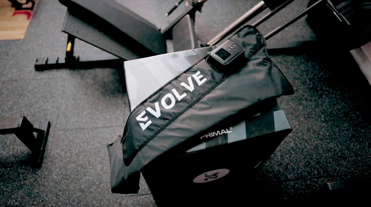 Compression recovery boots resting on a plyo box